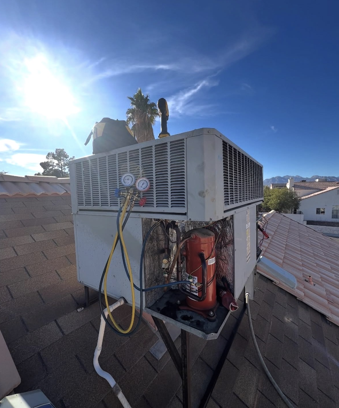 Priority Air Conditioning and Heating technician servicing an HVAC unit in Phoenix Metro